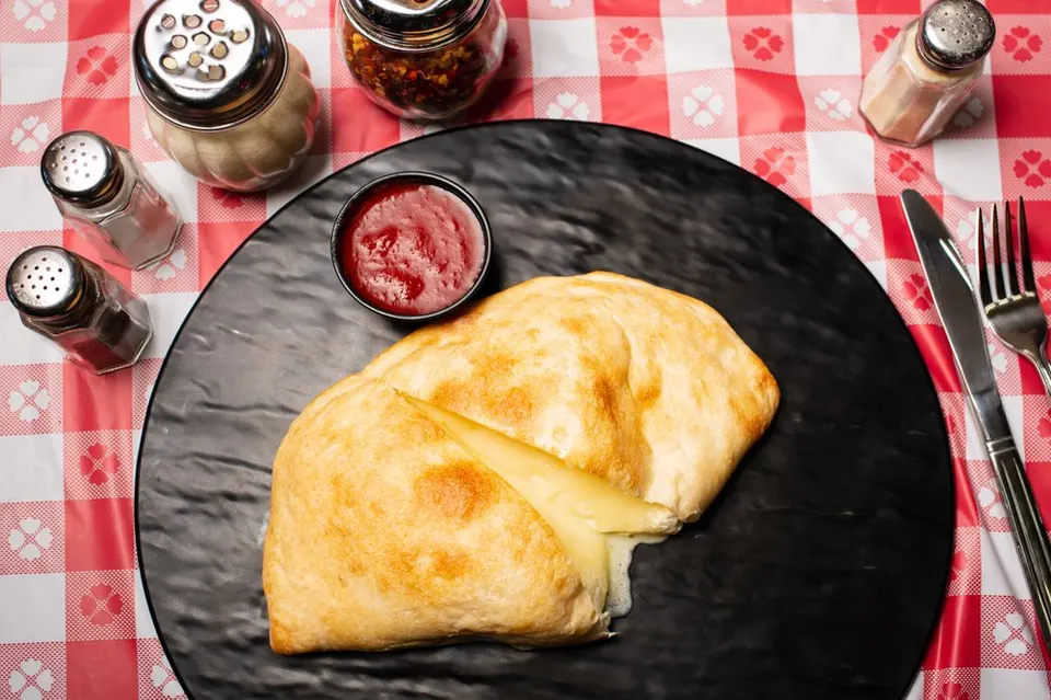 Golden calzone with sauce. Leo’s Pizza, Astoria.