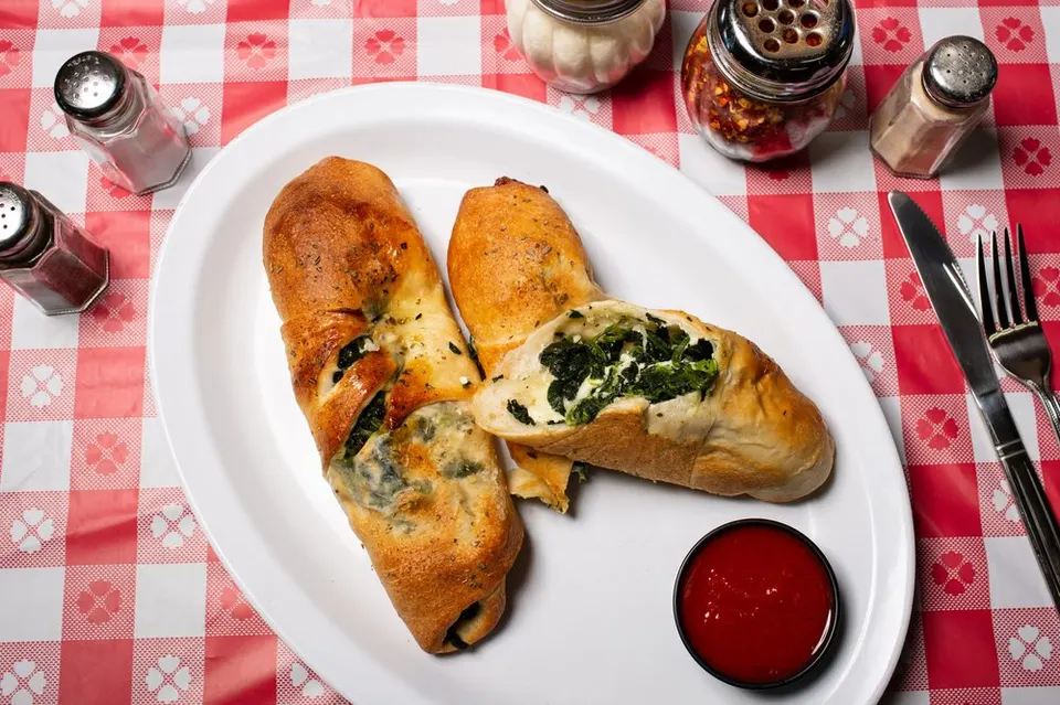 A freshly sliced stuffed roll. Leo’s Pizza, Astoria.